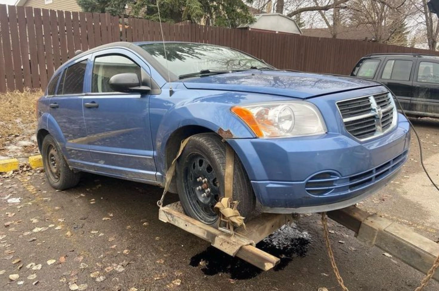 Old, damaged, and unattractive car being purchased for cash with free towing service