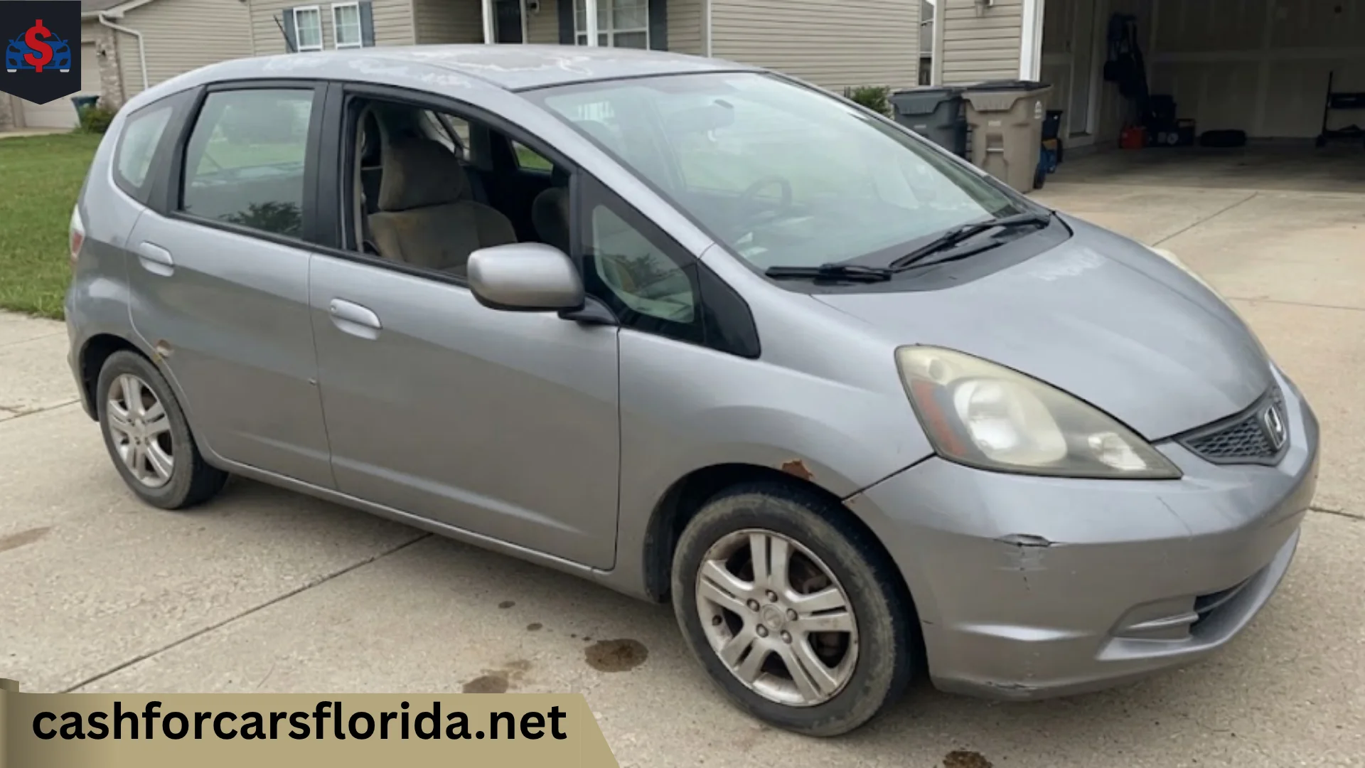 Damaged Honda Fit with rust and bumper scratches parked in a driveway, ready to sell for cash in Florida